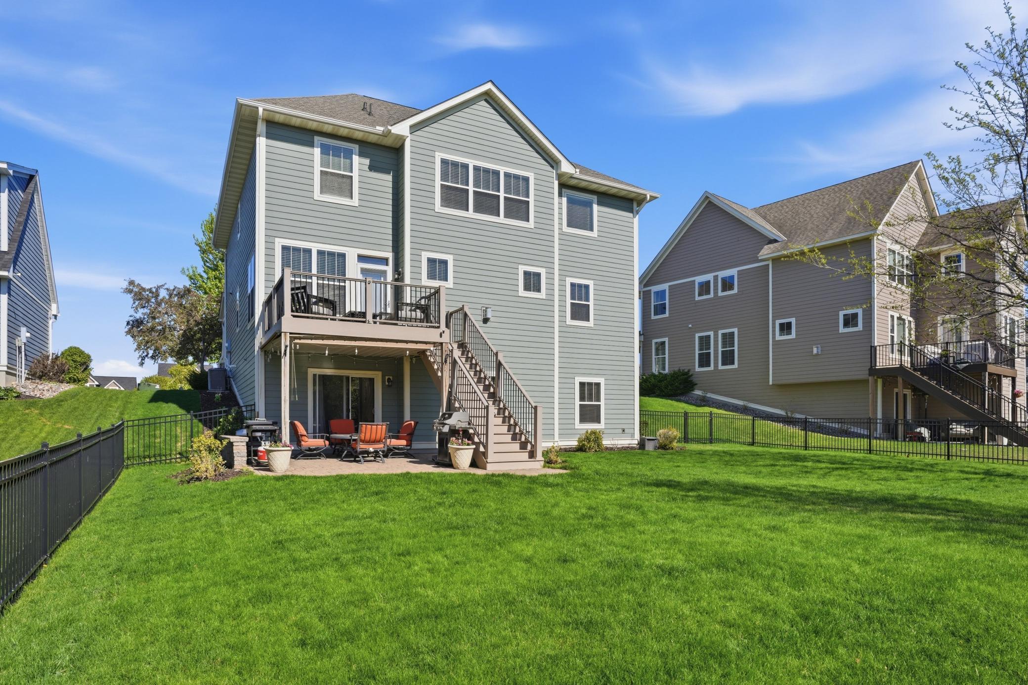 Relax and enjoy peaceful backyard views from the spacious deck and patio below.