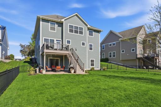 Relax and enjoy peaceful backyard views from the spacious deck and patio below.