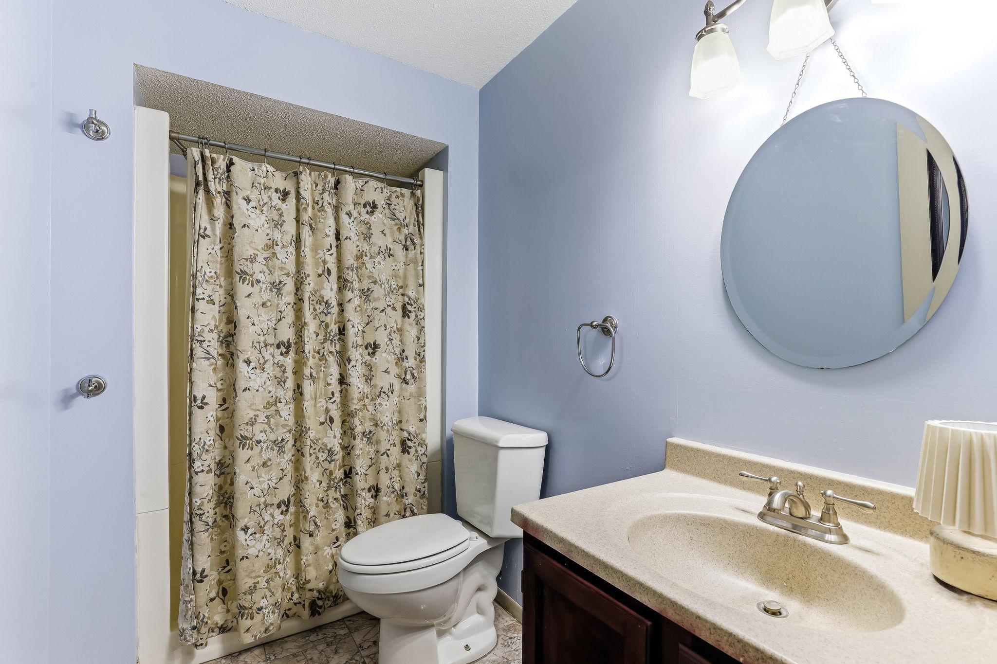 Additional lower-level bathroom with a functional layout, shower, neutral finishes, and convenient access to guests or lower-level living spaces.