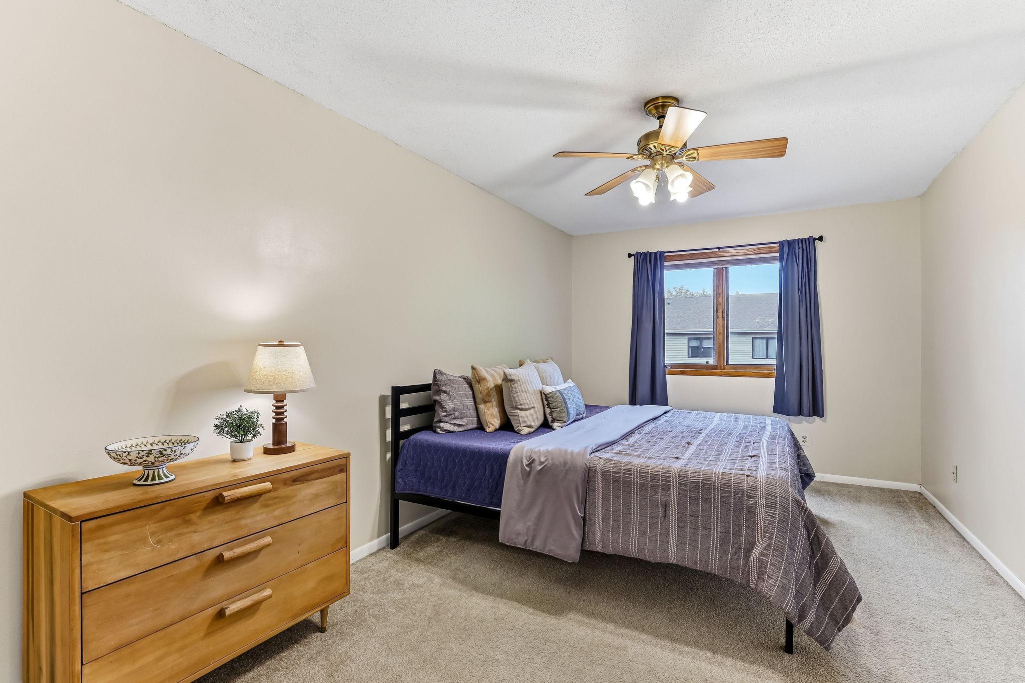Spacious primary bedroom with oversized layout, large window for natural light, walk-through access to the ensuite bath, and generous room for additional furniture or seating space.