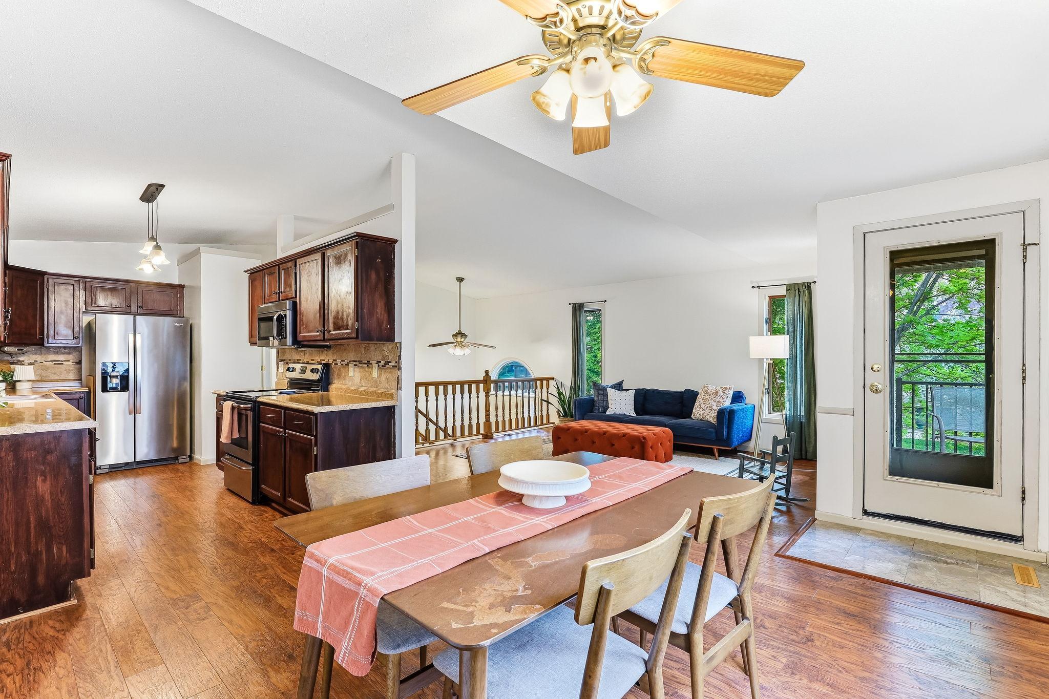 Open-concept kitchen, dining, and living area featuring updated flooring, stainless steel appliances, abundant cabinet storage, and seamless indoor flow in this well-maintained Inver Grove Heights townhome near parks and shopping.