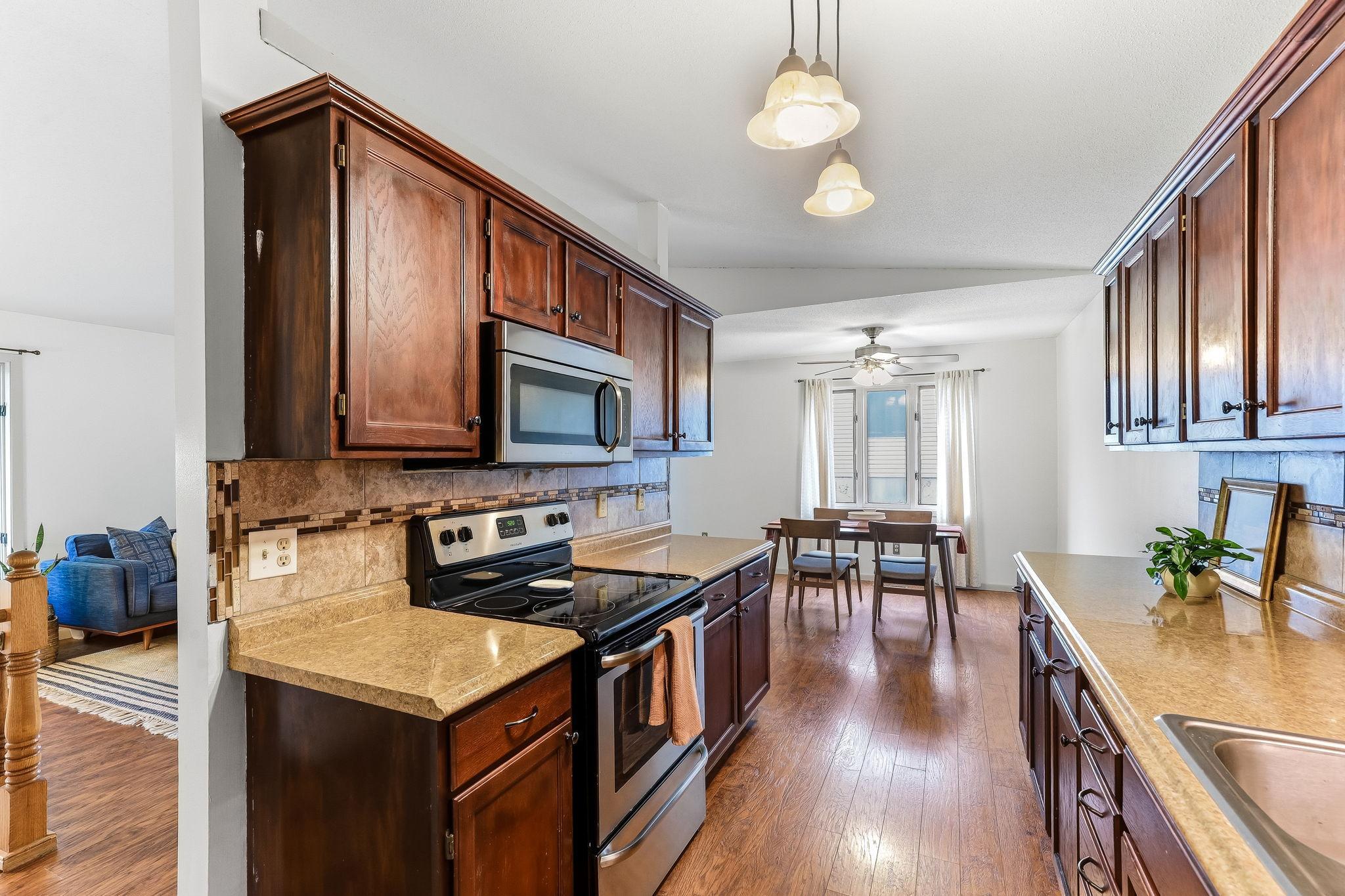Brilliant kitchen at 7653 Borman Way showcasing extensive cabinetry, durable countertops, modern appliances, and an efficient layout design ideal for everyday cooking and entertaining in the Twin Cities metro area.