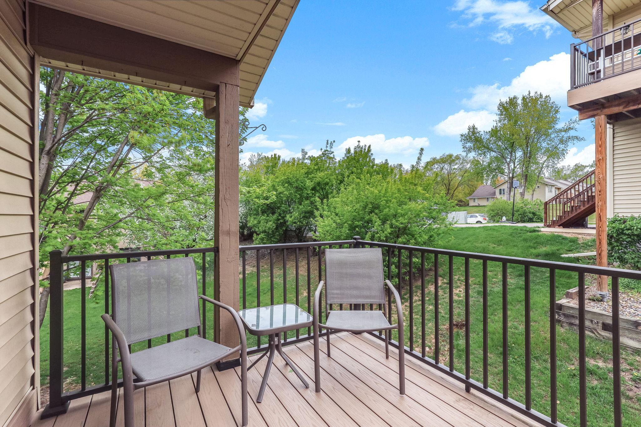 Private outdoor deck at this Inver Grove Heights townhome offering peaceful tree-lined views, low-maintenance outdoor living, and the perfect space for morning coffee or relaxing.