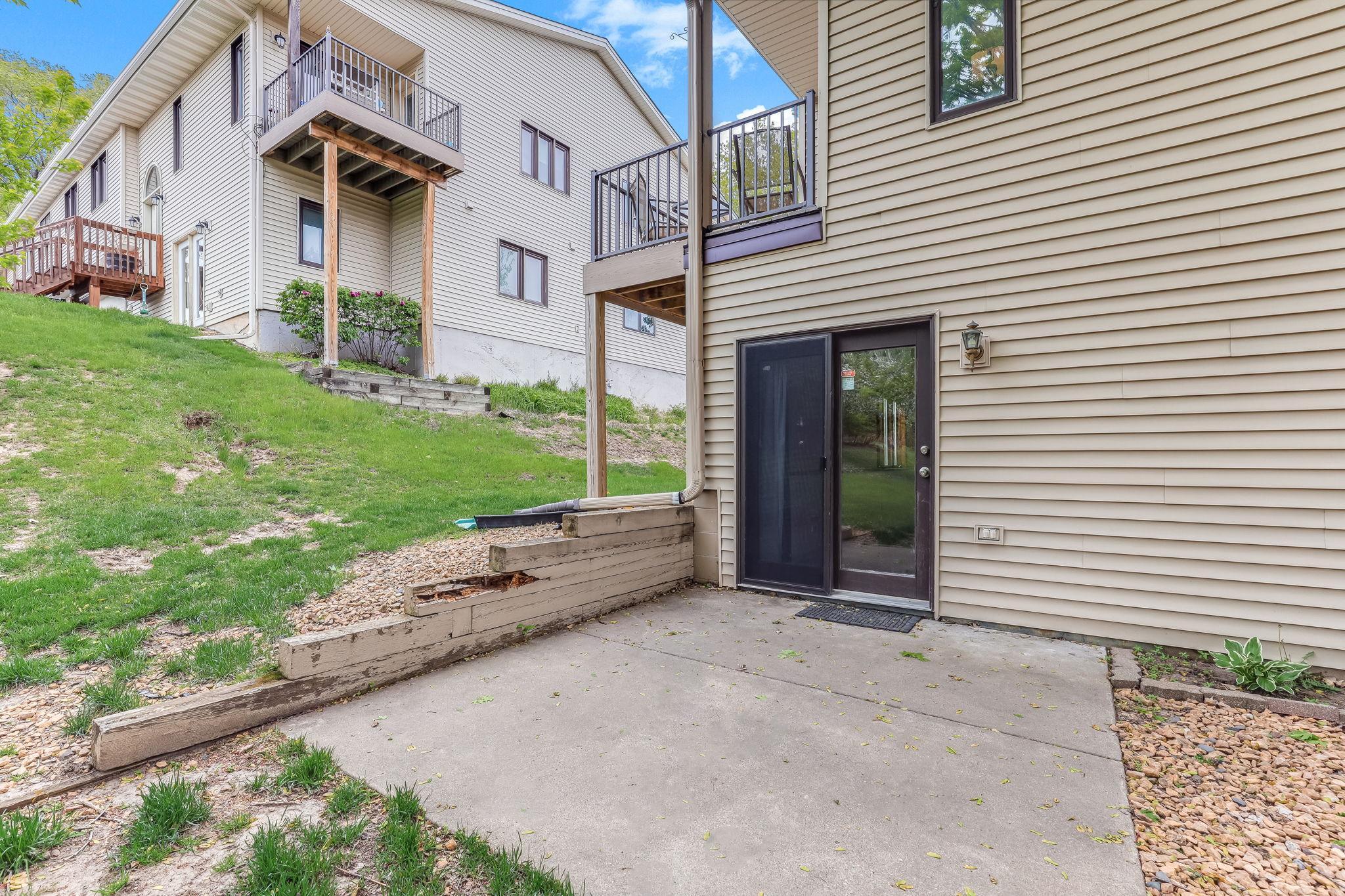 Walkout lower-level patio area provides additional outdoor living space with direct access to the backyard and lower-level family room.