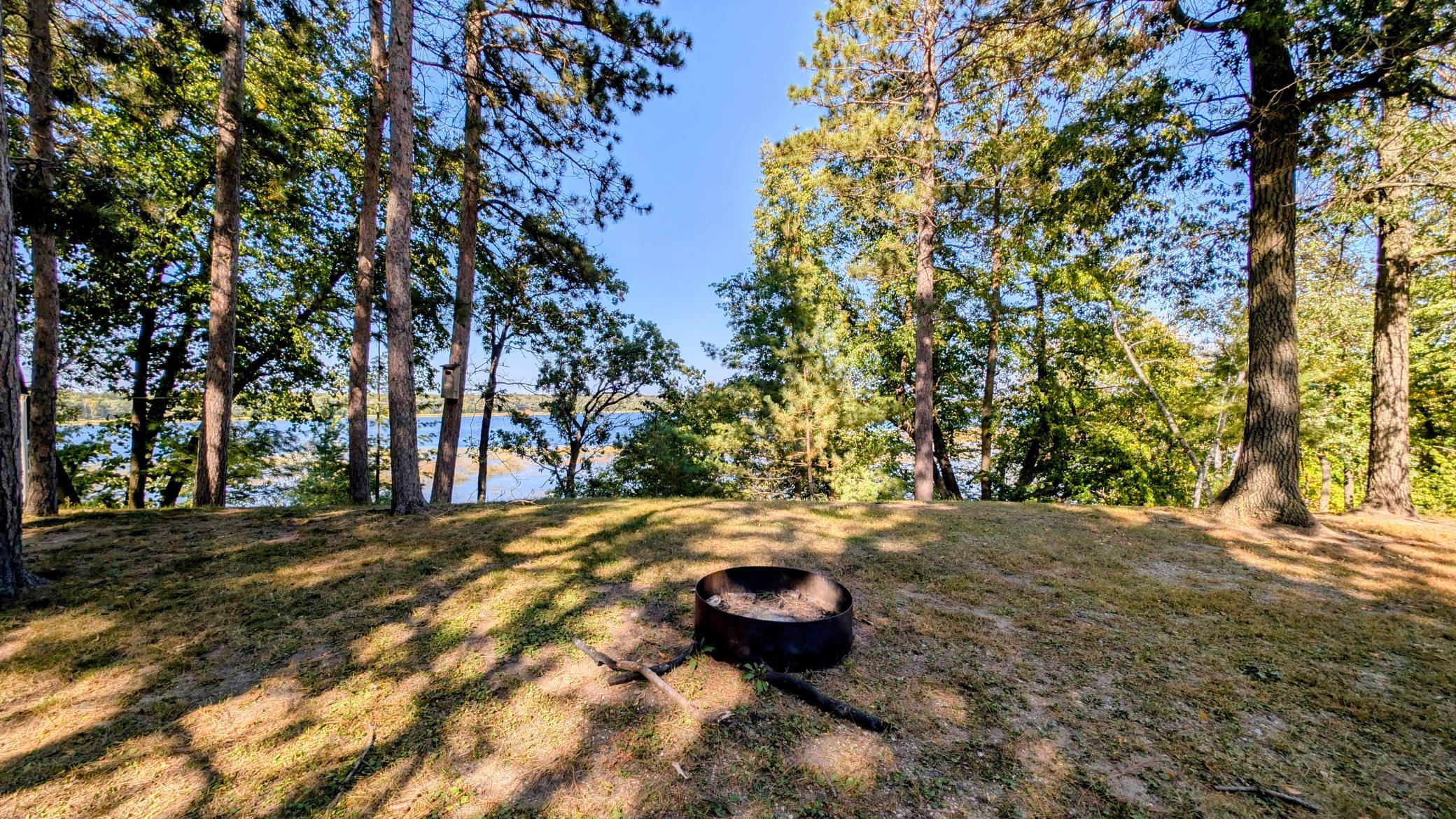 Firepit on east side of property with stairs to dock.