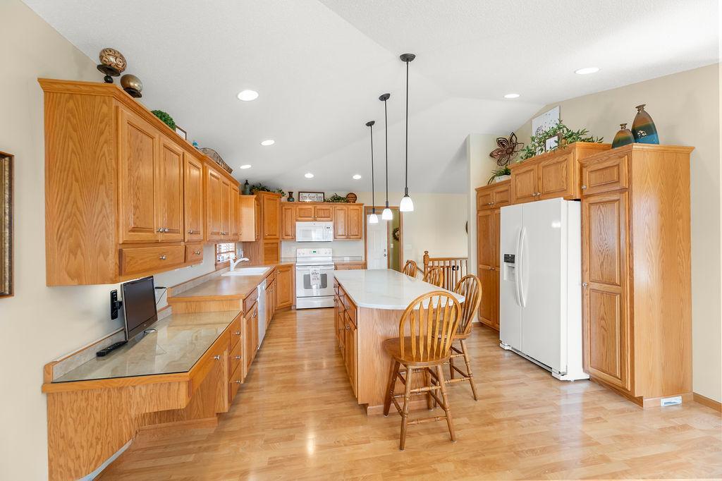 Huge kitchen with center island, vaulted ceilings, tons of cabinetry.