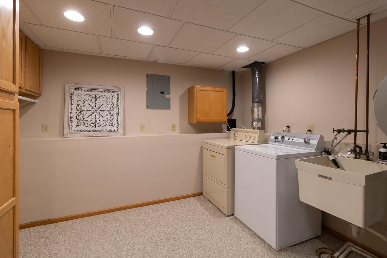 Finished laundry room with space for folding and hanging.