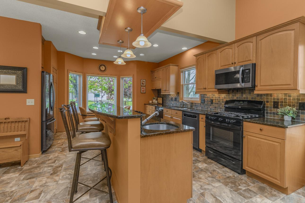The 2-tier island includes a second sink and ingetrated gas burners.
