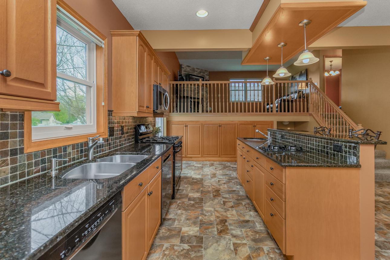 Tile backsplash and elevated light fixtures offer a modern vibe in this totally reimagined space.