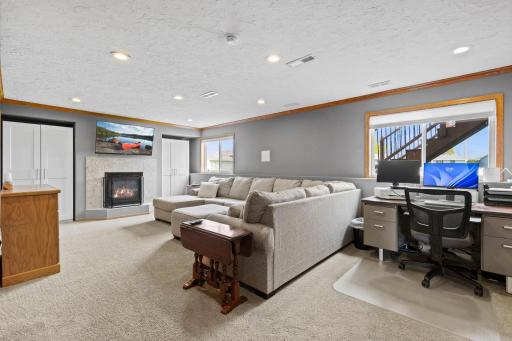 Lower level opens to a spacious family room centered around a gas fireplace