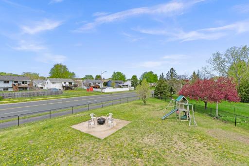 Deck overlooks the large yard featuring a firepit pad, ideal for entertaining or enjoying quiet nights outdoors