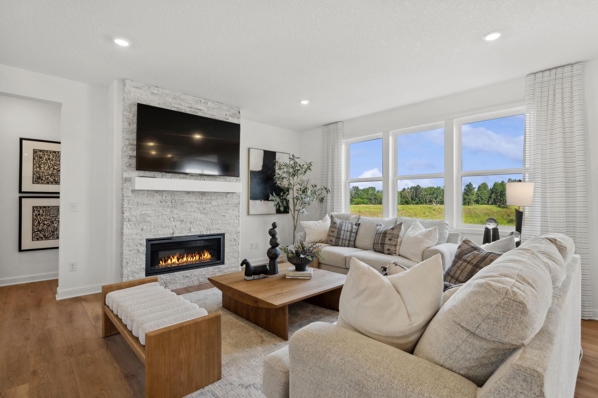 (Photo of a decorated model, actual homes finishes will vary) The family room is the perfect place to relax next to the fire.
