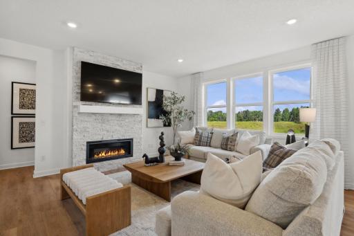 (Photo of a decorated model, actual homes finishes will vary) The family room is the perfect place to relax next to the fire.