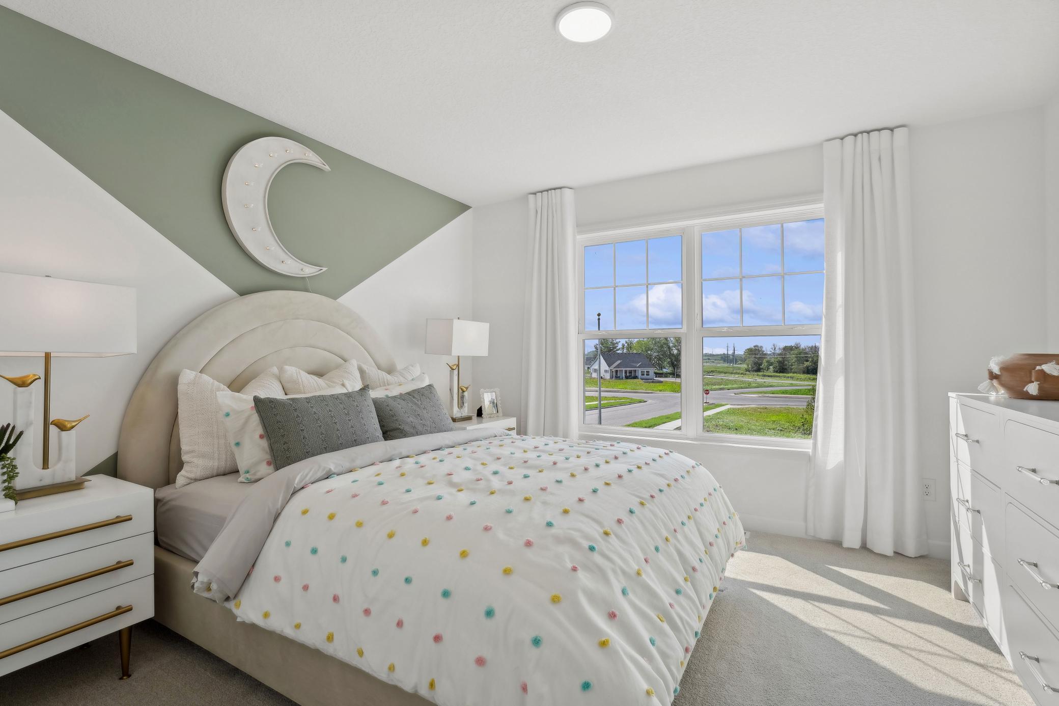 (Photo of a decorated model, actual homes finishes will vary) One of the three spacious secondary bedrooms on the upper level.