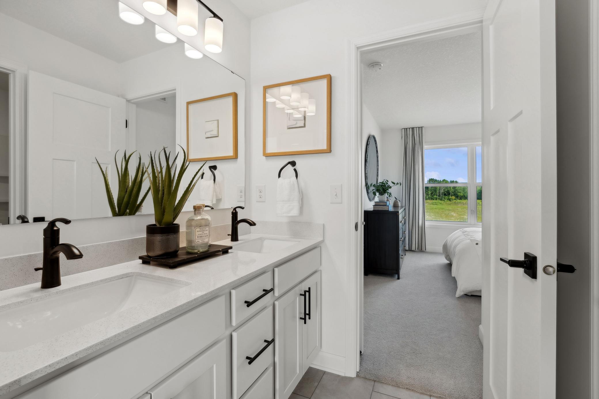 (Photo of a decorated model, actual homes finishes will vary) The Jack and Jill bath connects two of the secondary bedrooms.