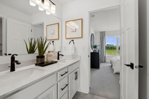 (Photo of a decorated model, actual homes finishes will vary) The Jack and Jill bath connects two of the secondary bedrooms.