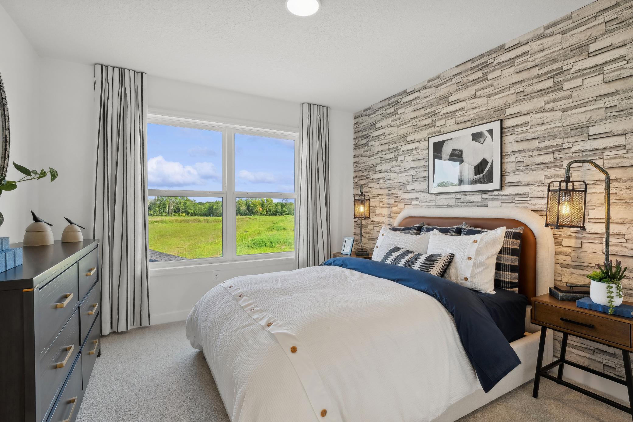 (Photo of a decorated model, actual homes finishes will vary) The third secondary bedroom on the upper level.