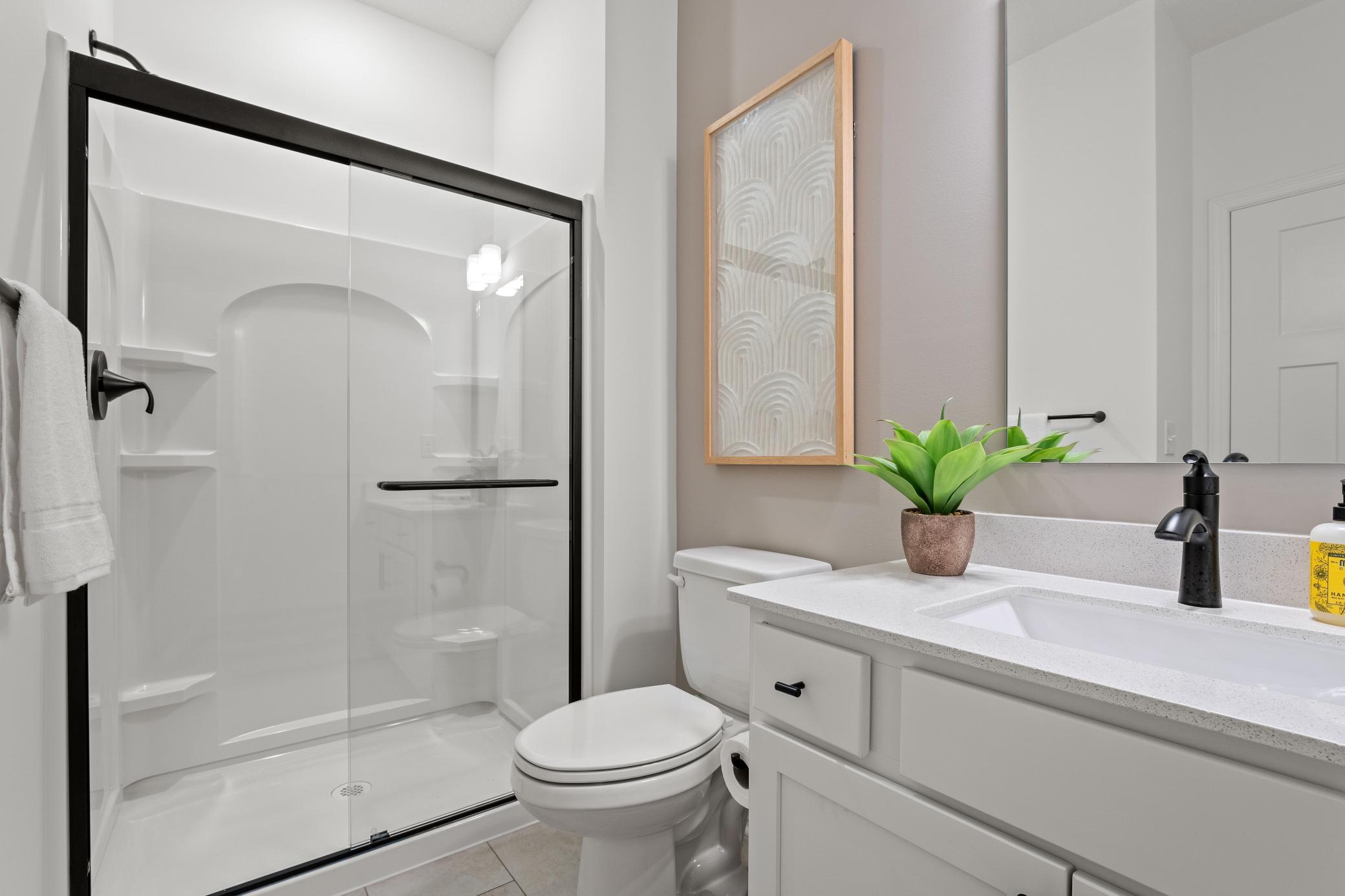 (Photo of a decorated model, actual homes finishes will vary) One of the secondary bedrooms has an en-suite bath.