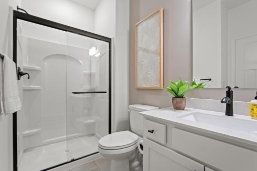 (Photo of a decorated model, actual homes finishes will vary) One of the secondary bedrooms has an en-suite bath.