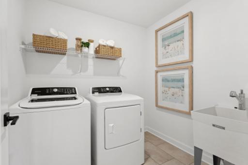 (Photo of a decorated model, actual homes finishes will vary) Upper level laundry. Note: appliances are not included.