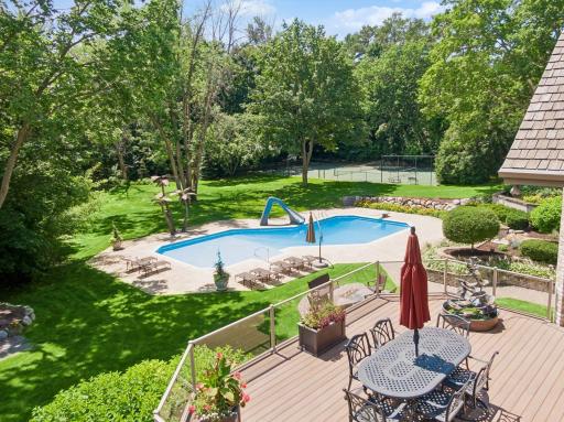 Maintenance free deck with private views of the pool, tennis court, and room to run and play.