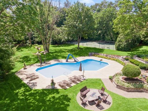 Privately fenced in yard with tennis court