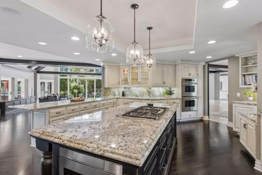 High end stainless steel appliances, spacious center island, and hardwood flooring throughout.