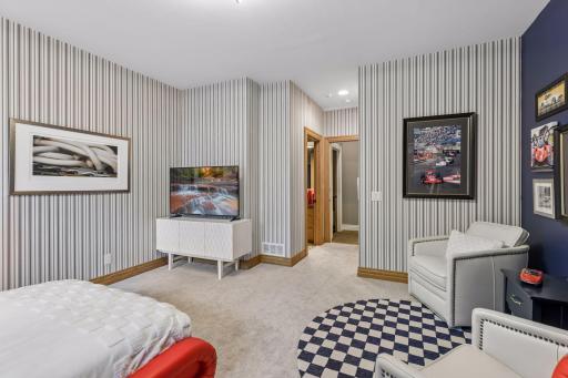 Fifth bedroom on the lower level with walk-in closet and full bathroom
