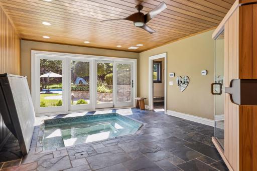 Wellness room with below ground hot tub, space for a sauna, and access the backyard