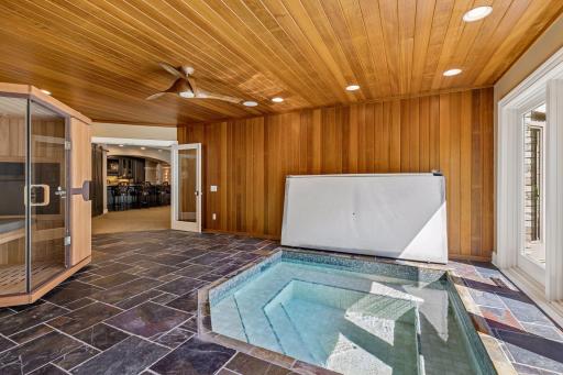 Wellness room with below ground hot tub, space for a sauna, and access the backyard