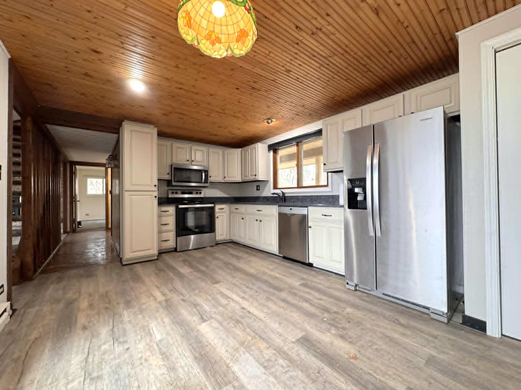 Kitchen with stainless appliances and natural light coming in.jpg