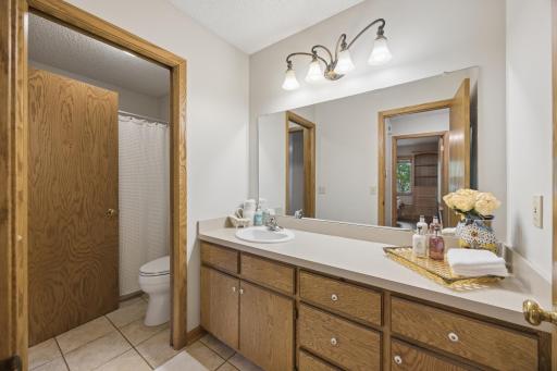 Bright upper-level bathroom with an expansive vanity, excellent storage, and clean neutral finishes ready for your personal touch.