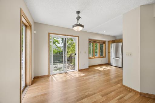Bright and welcoming dining space with direct access to the deckâperfect for indoor-outdoor entertaining and enjoying peaceful backyard views.