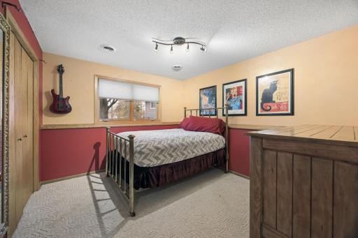 Bedroom 3 of 4 - Lower-level bedroom with U of M accent walls, cozy finishes, and flexible space for guests, hobbies, or creative use.