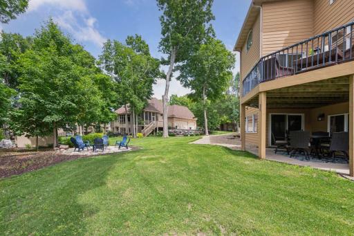 Enjoy a peaceful, private setting with expansive green space in the front and back, towering trees, and thoughtfully designed outdoor living areas perfect for relaxing or entertaining.