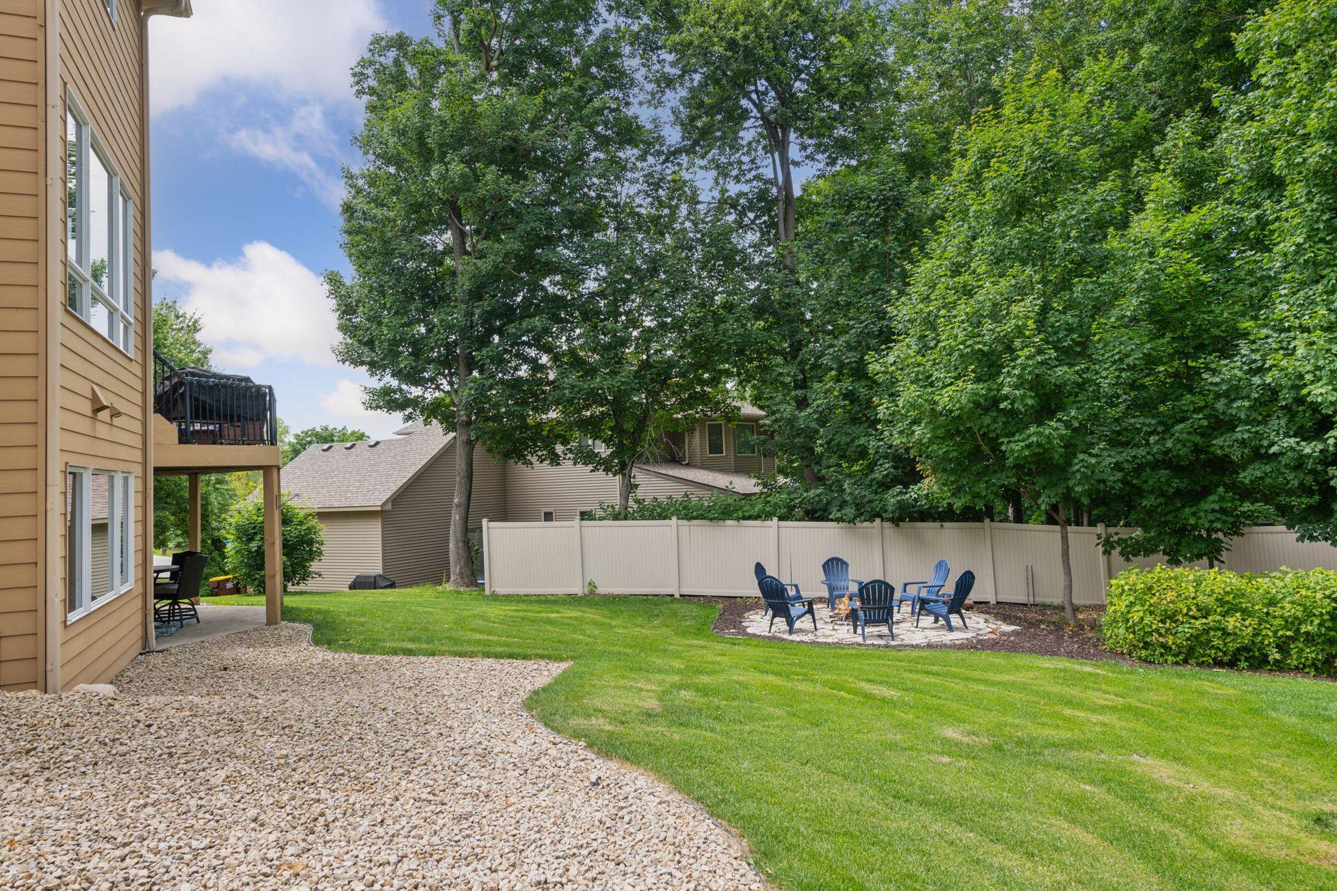 The flat, usable yard offers exceptional space for recreation, pets, and outdoor enjoyment while maintaining a serene, wooded atmosphere in the front and backyard.
