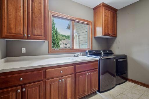Convenient ML laundry with a ton of cabinetry, built-ins! No shortage of space to fold clothes.