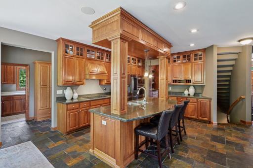 Exceptional chefâs kitchen showcasing rich cherry cabinetry, extensive custom millwork, and timeless architectural detail throughout. Stunning floors adds warmth and texture, perfectly complementing the elegant wood finishes and craftsmanship