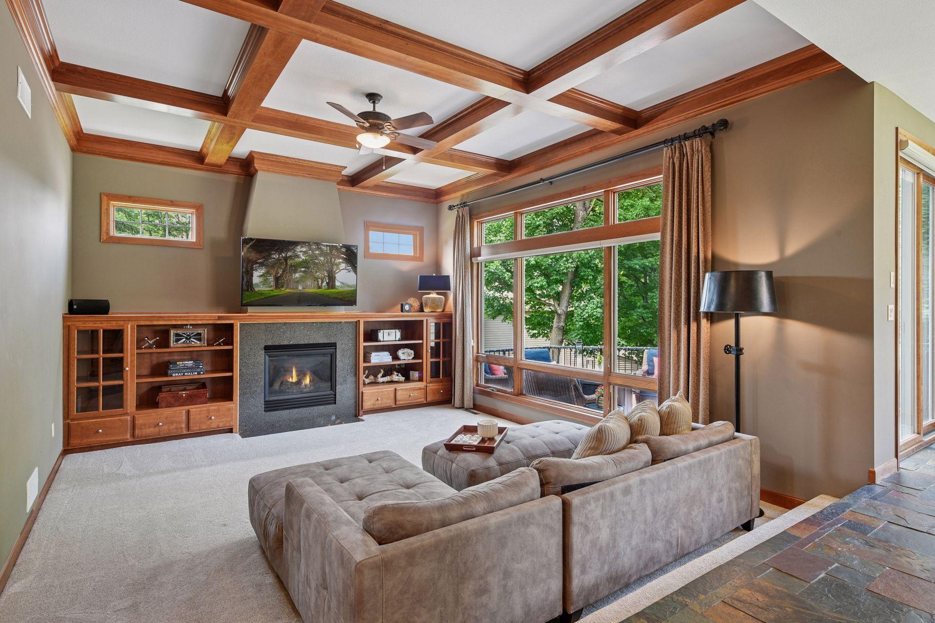 Exceptional craftsmanship shines throughout with custom built-ins, soaring ceilings, stunning wood beams, and dramatic floor-to-ceiling windows that fill the home with natural light.