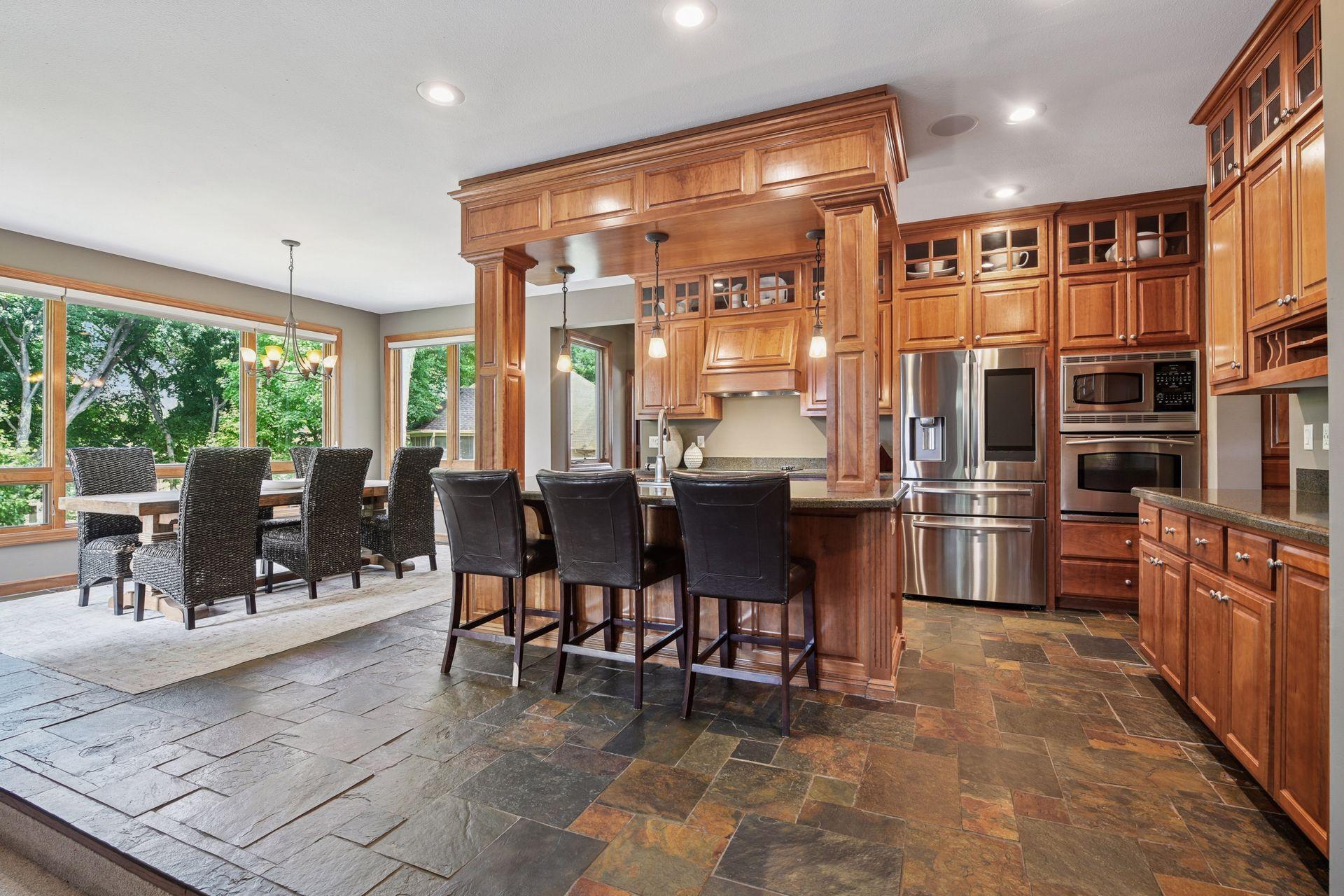 At the center of the space, a dramatic raised island with stylish column accents, and decorative trim creates a true gathering space—perfect for entertaining and everyday living.