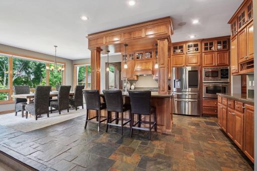At the center of the space, a dramatic raised island with stylish column accents, and decorative trim creates a true gathering spaceâperfect for entertaining and everyday living.