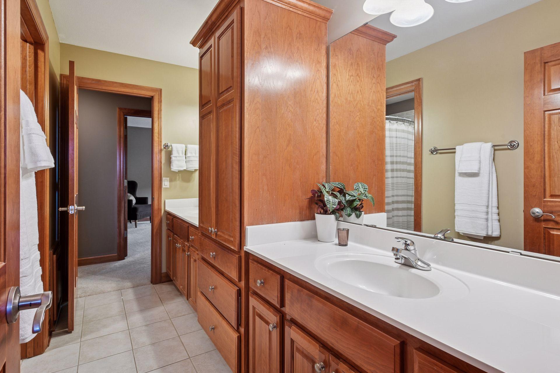 Jack and Jill bathroom between upper bedroom offers great linen storage and seperate sinks / vanity spaces.