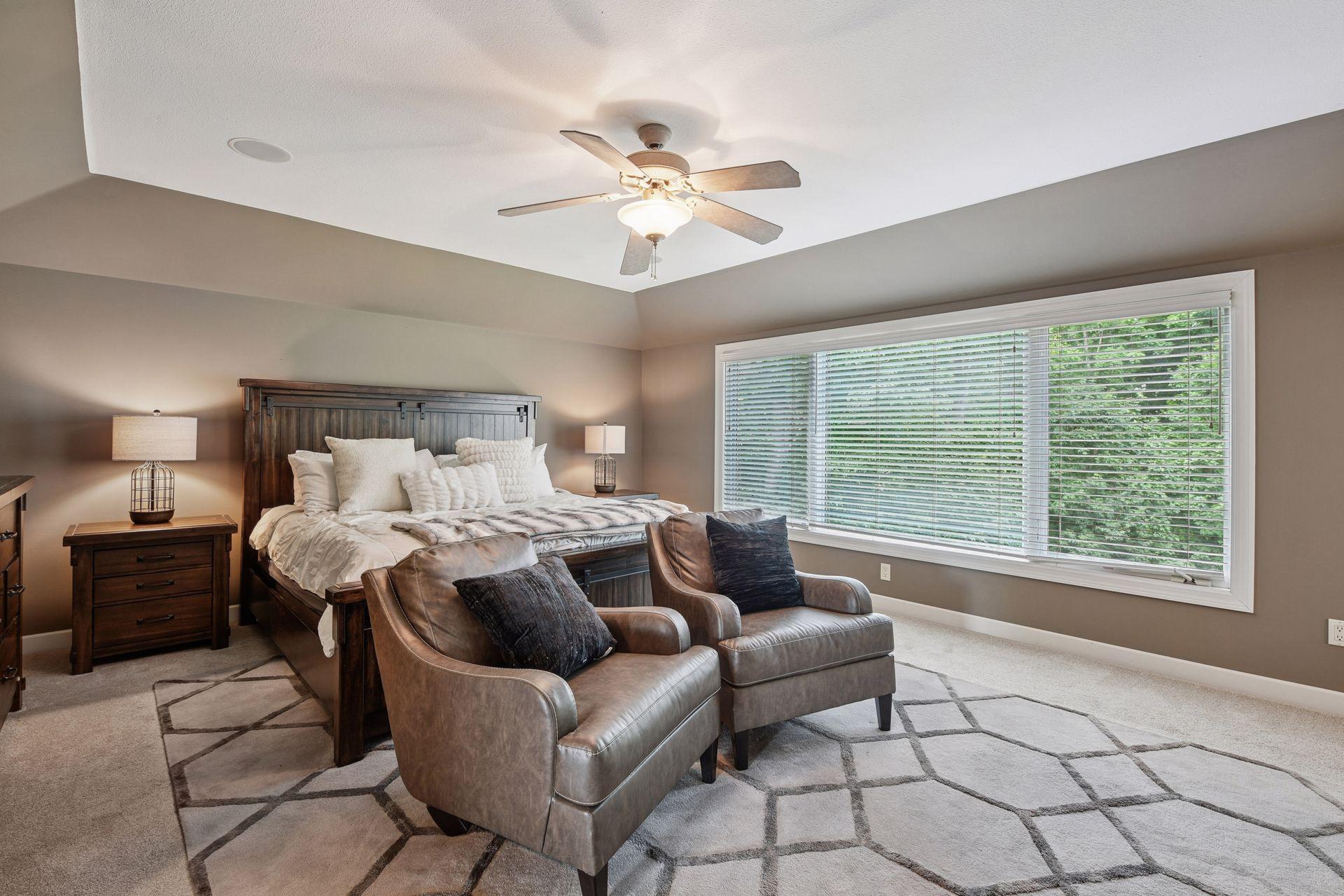 Beautifully sized owner’s suite offers the perfect blend of comfort and luxury. Large picture window frames serene wooded views while enhancing the bright and inviting space.