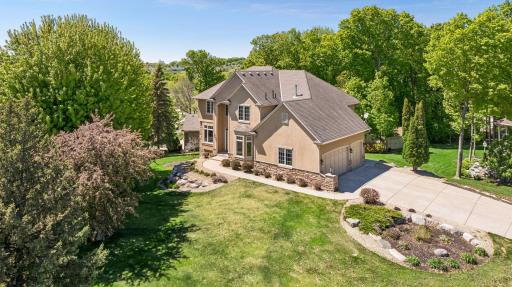 Spectacular corner lot offers wonderful privacy, long concrete driveway for extra parking, beautiful stone landscaping, great outdoor spaces - patio, firepit, and deck!