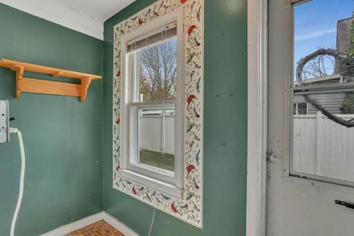 Isn't this little entry porch adorable? Just big enough to catch all those things that come in with you from the backyard.