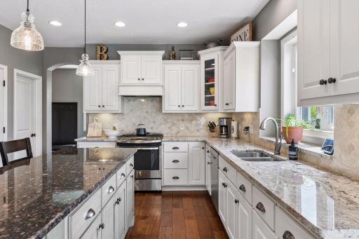 Delightful finishing details include staggered cabinet heights with crown molding, recessed kitchen window, and under-cabinet lighting