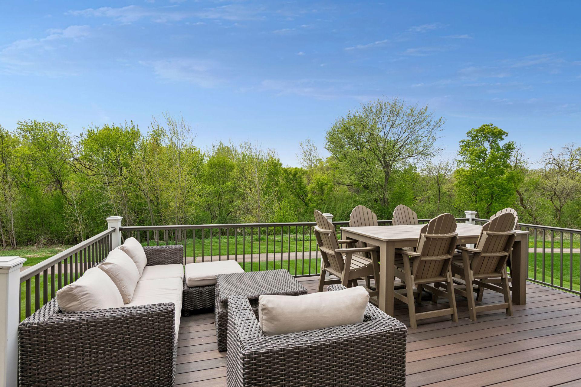 Enjoy the backyard views from the expansive maintenance-free deck overlooking the neighborhood trail, and 38-acres of city owned land (including Bluff Creek)
