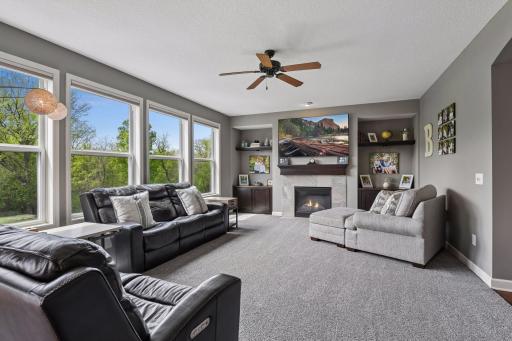 Another view of the cozy family room with abundant natural light and gas fireplace