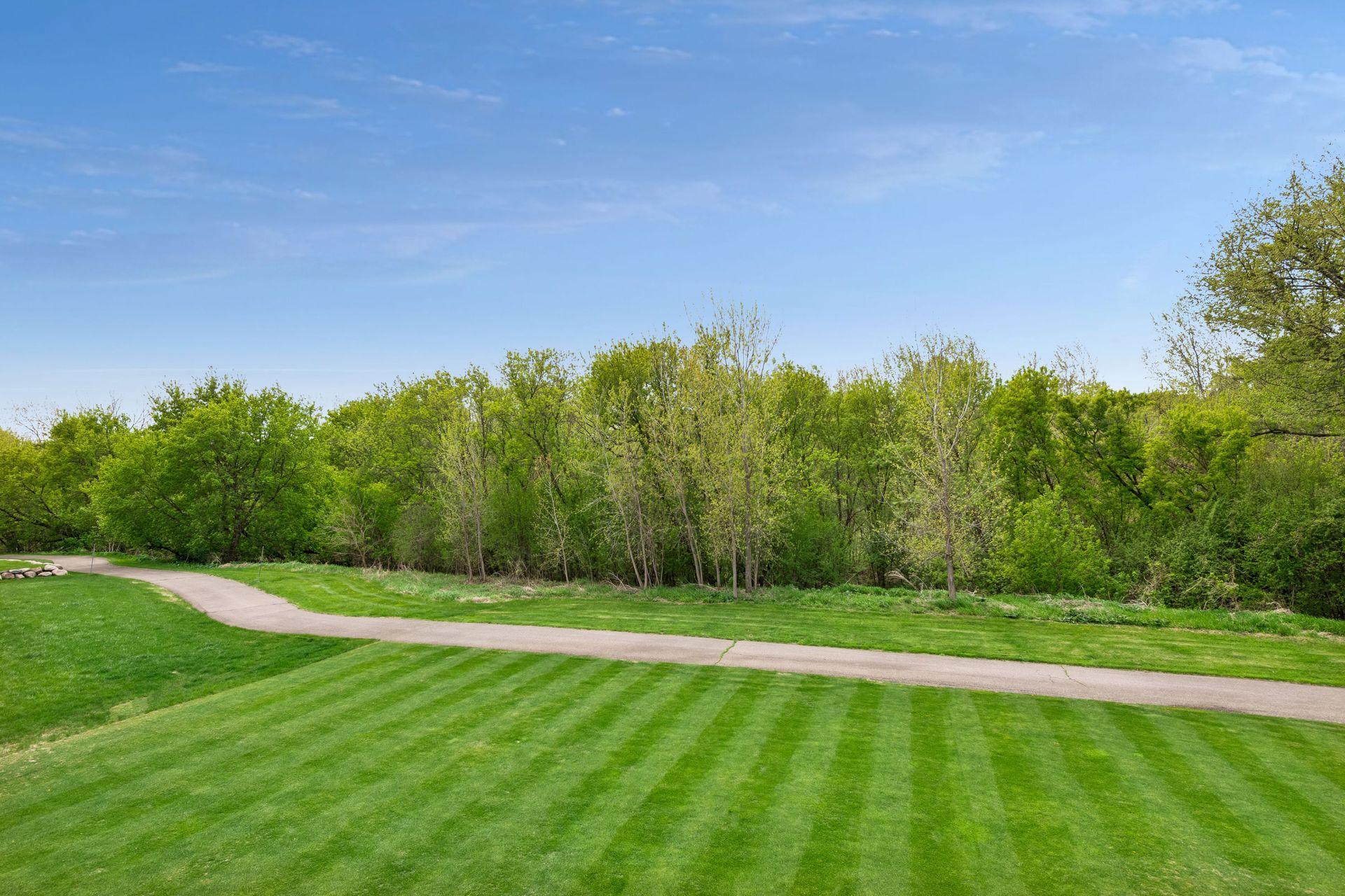 Expansive, level lawn backing up to 38 acres of city-owned land, including Bluff Creek
