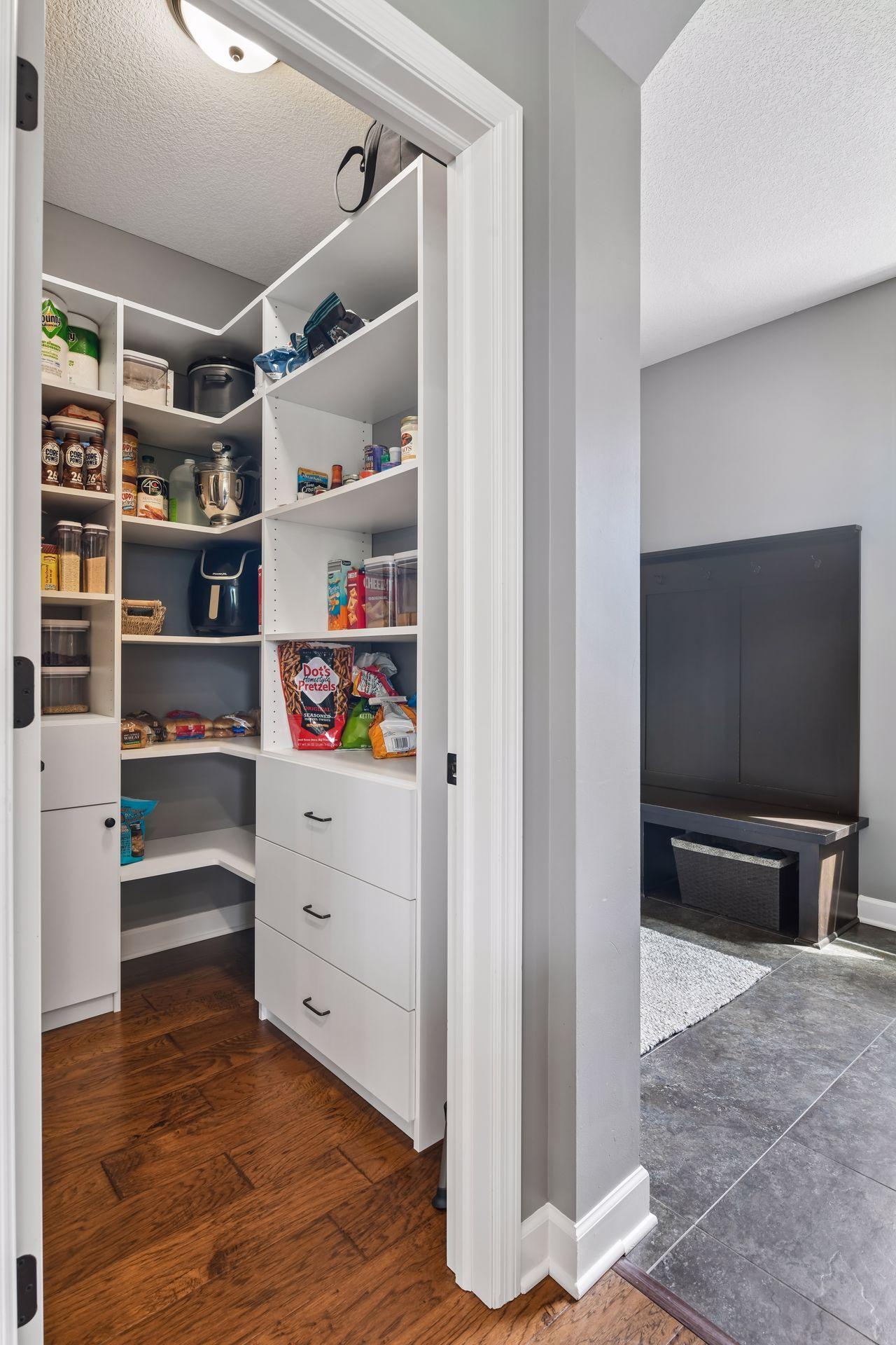 Fabulous walk-in pantry with custom built-in shelving and storage